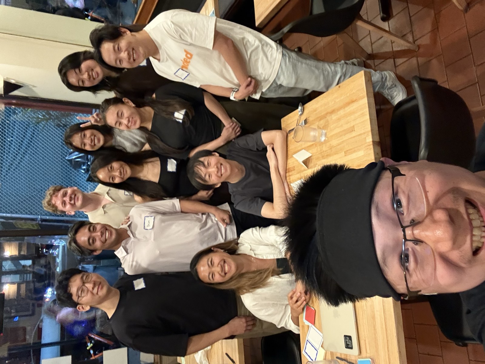 A closing group selfie with everyone who came to Turn and Talk crowded into frame around the tables.